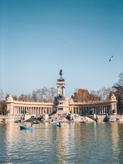 people riding on boat on river near brown concrete building during daytime