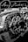 An intricate assembly of metallic gears and mechanical components with detailed reflections on a glossy surface. The scene includes circular cogs and patterns, suggesting a focus on machinery or a mechanical design project.