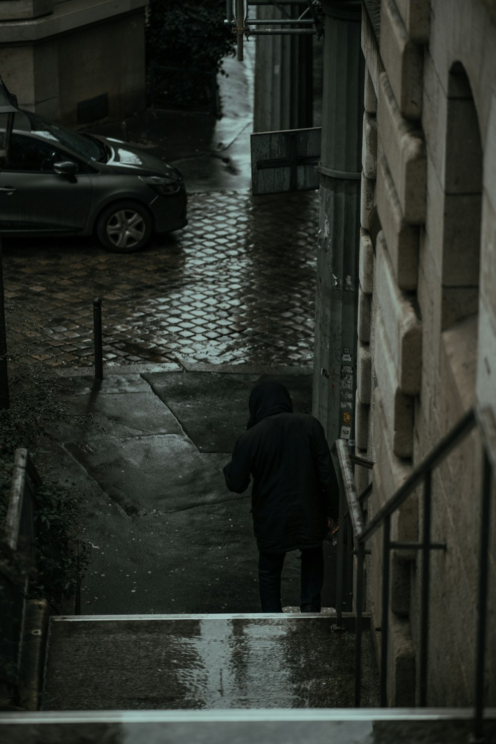 man in black jacket walking on sidewalk during daytime