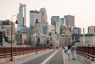 people walking on sidewalk near city buildings during daytime