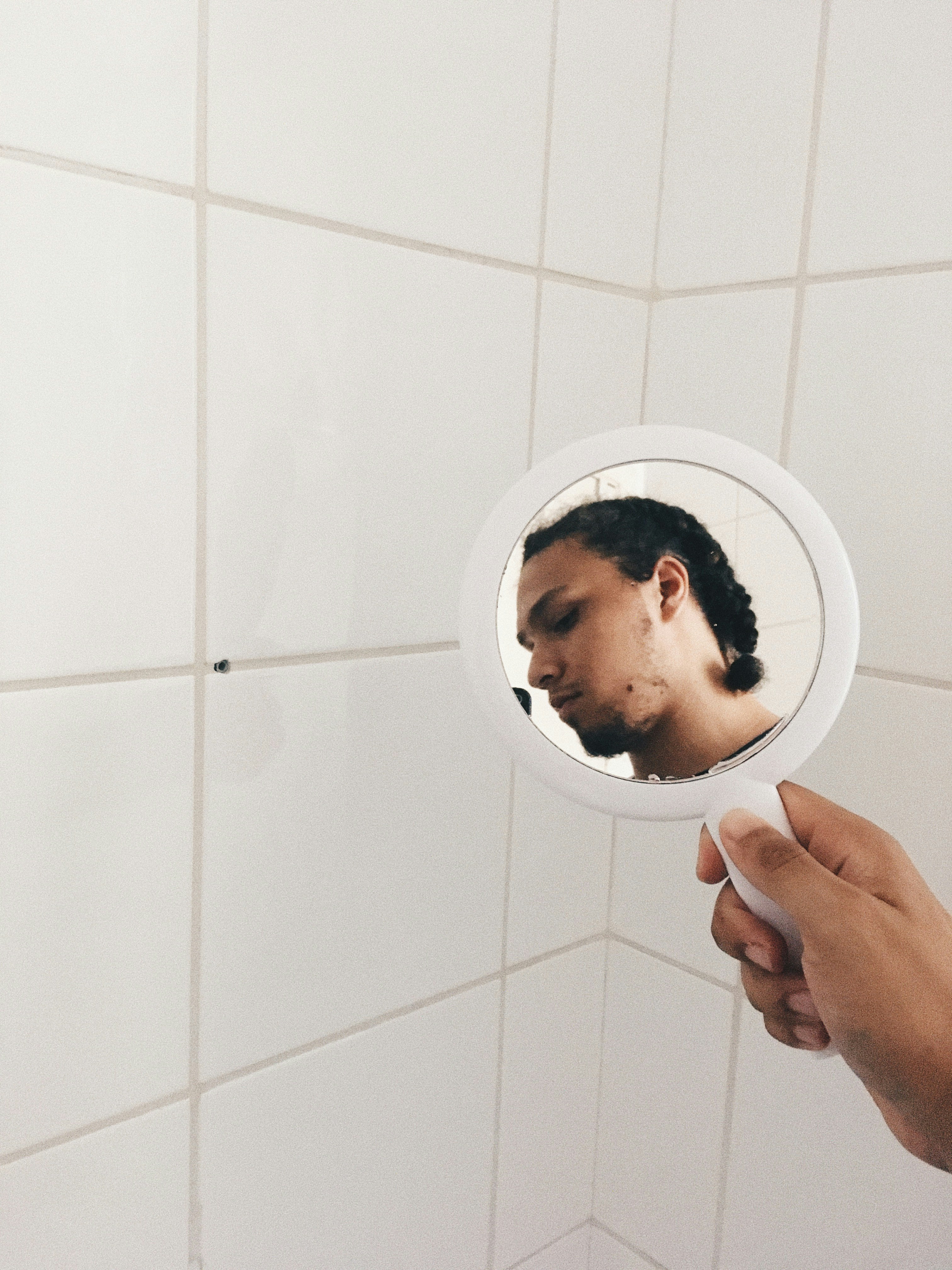 person holding white round plate