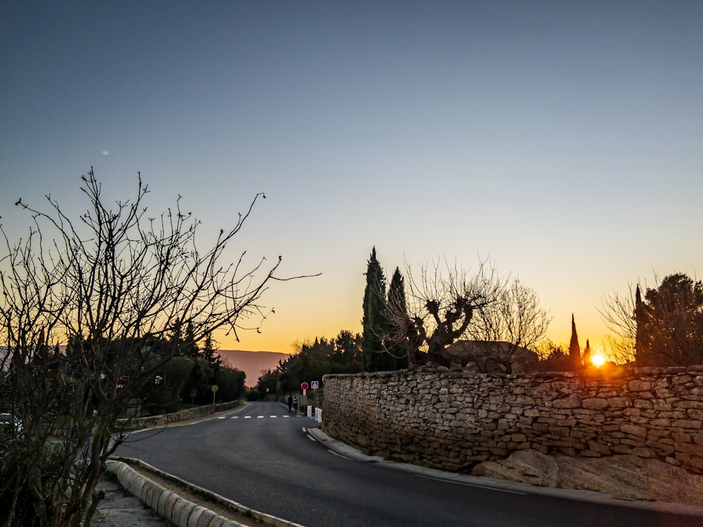 gray asphalt road during sunset