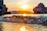 A close-up shot of gentle ocean waves reflecting the soft glow of a sunset.
