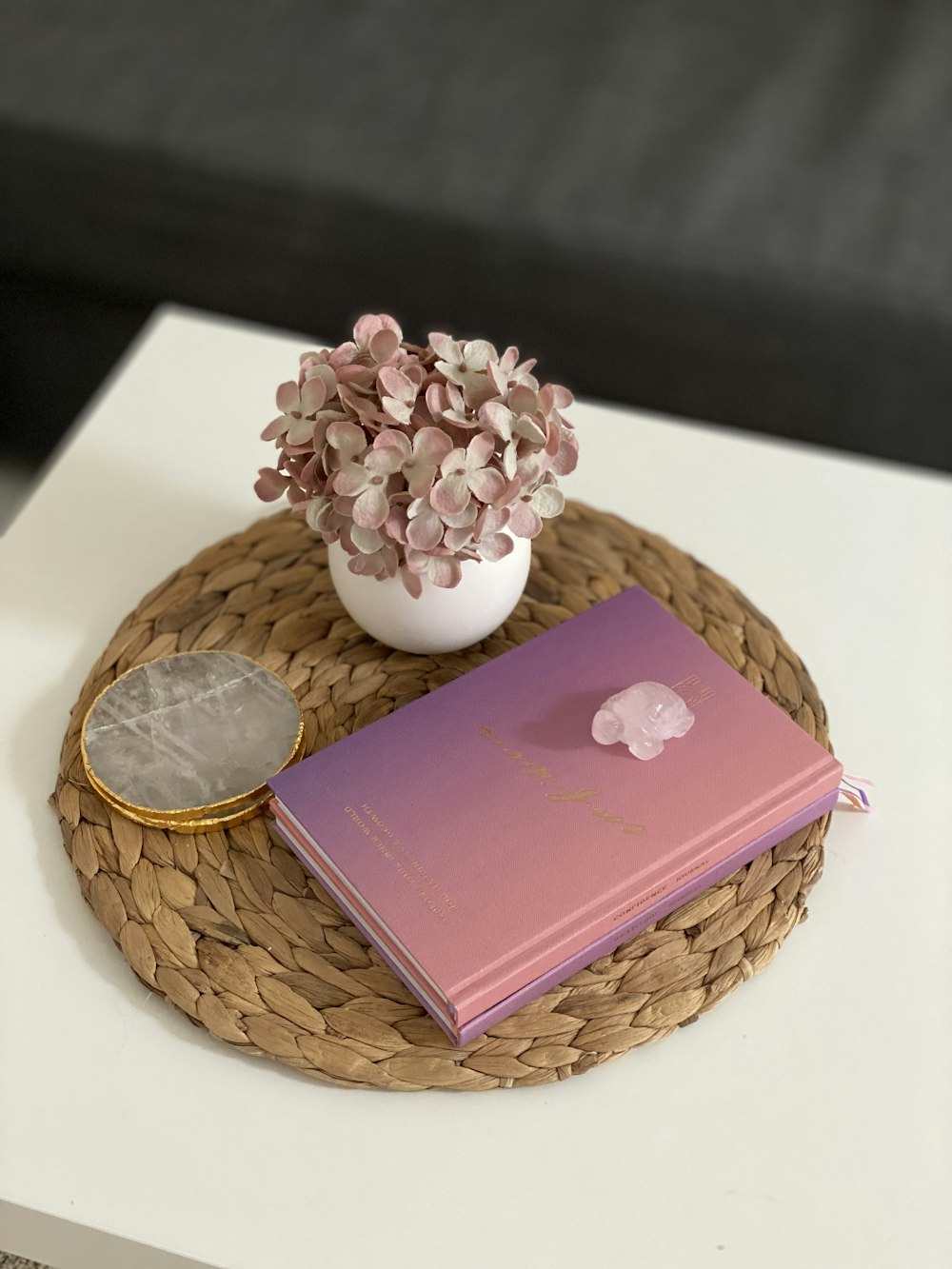 pink book on brown woven round basket