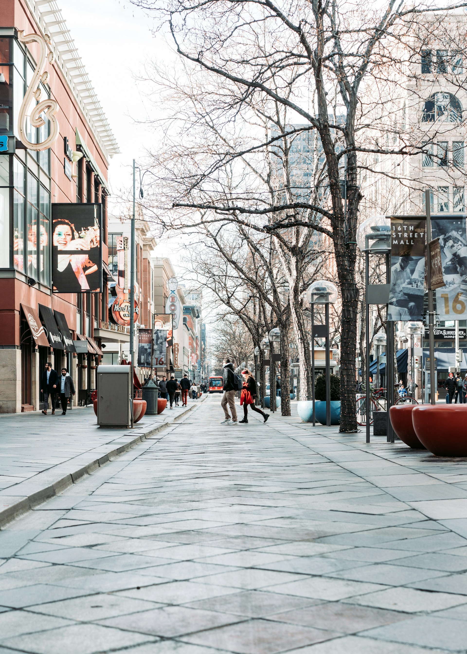 people walking on sidewalk near brown building during daytime