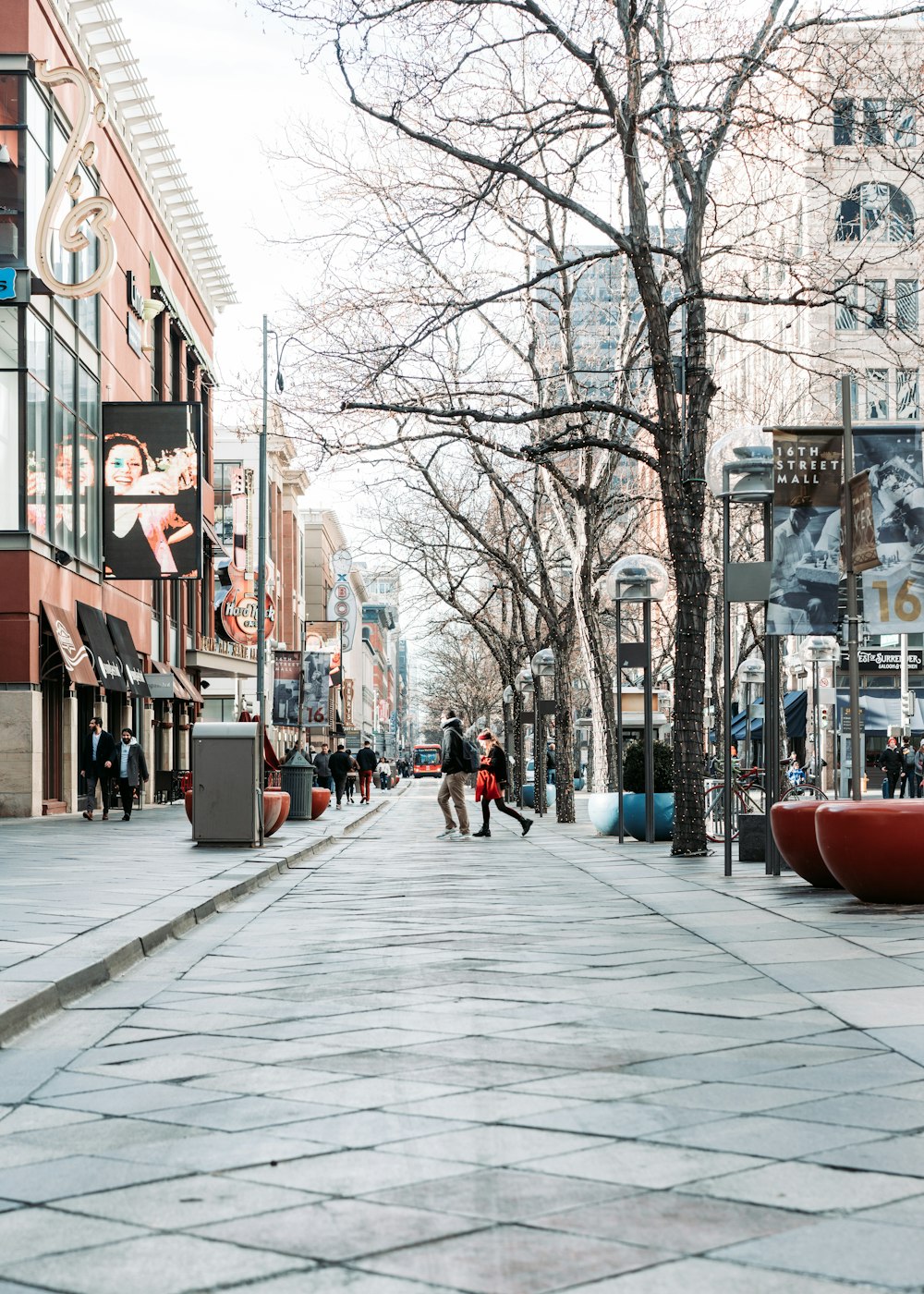 people walking on sidewalk near brown building during daytime