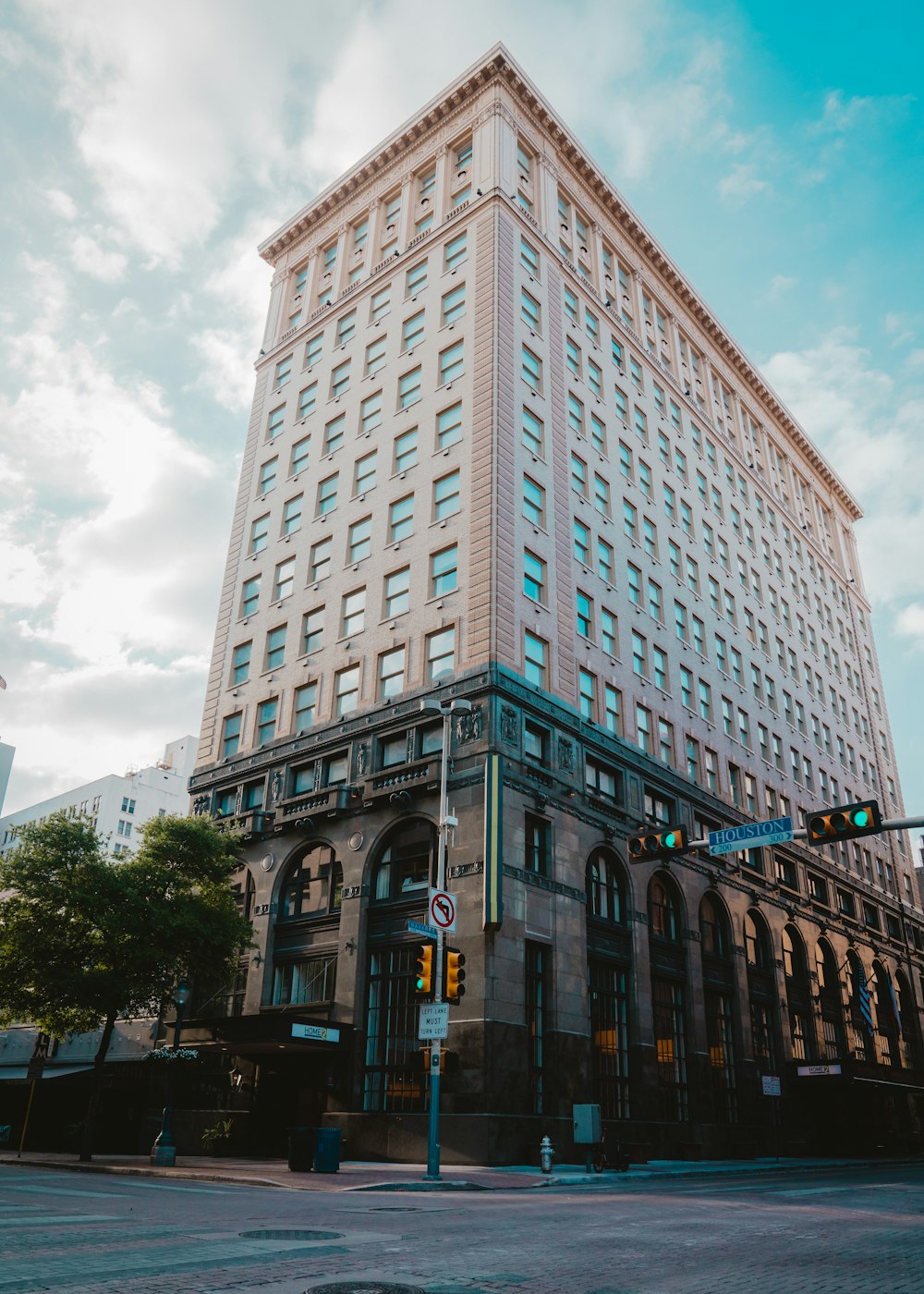 brown concrete building under white clouds during daytime