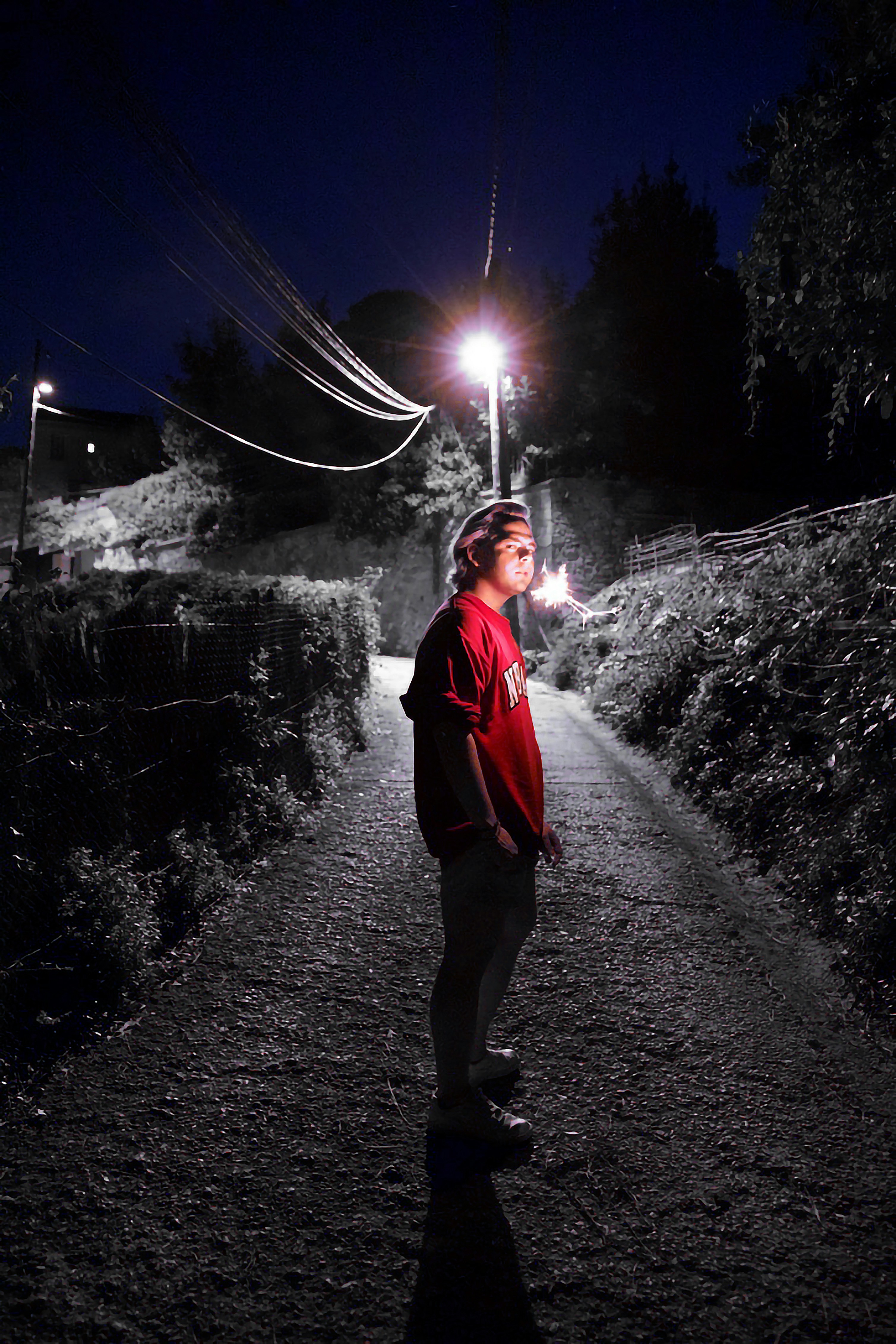 Person standing on a path at night