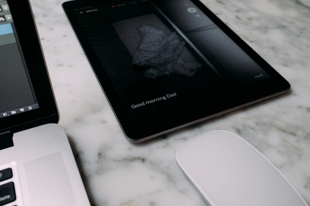 black samsung galaxy smartphone on white table