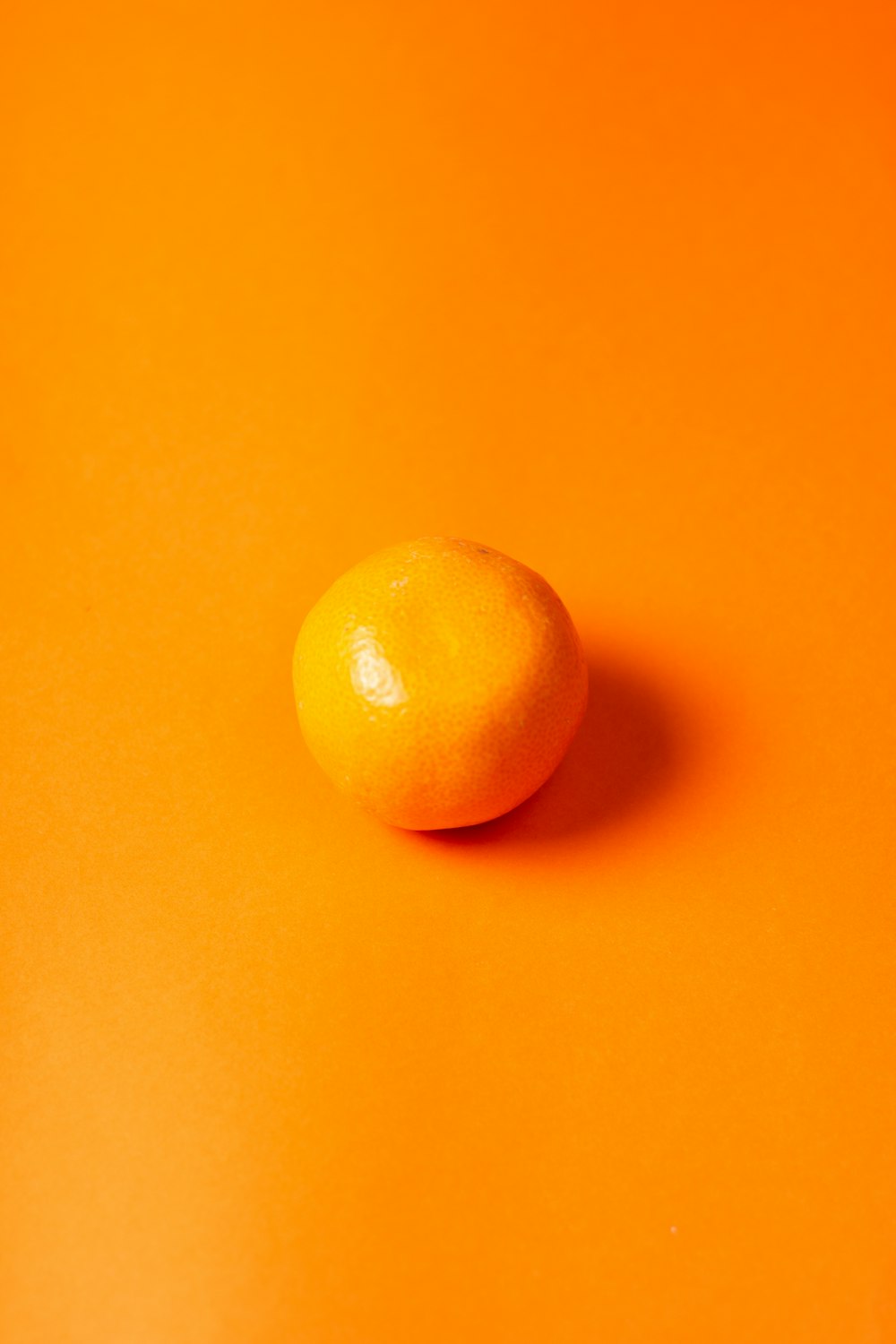 orange fruit on yellow surface