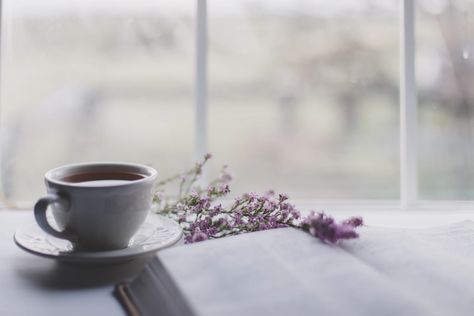 A warm cup of tea by a window in the morning