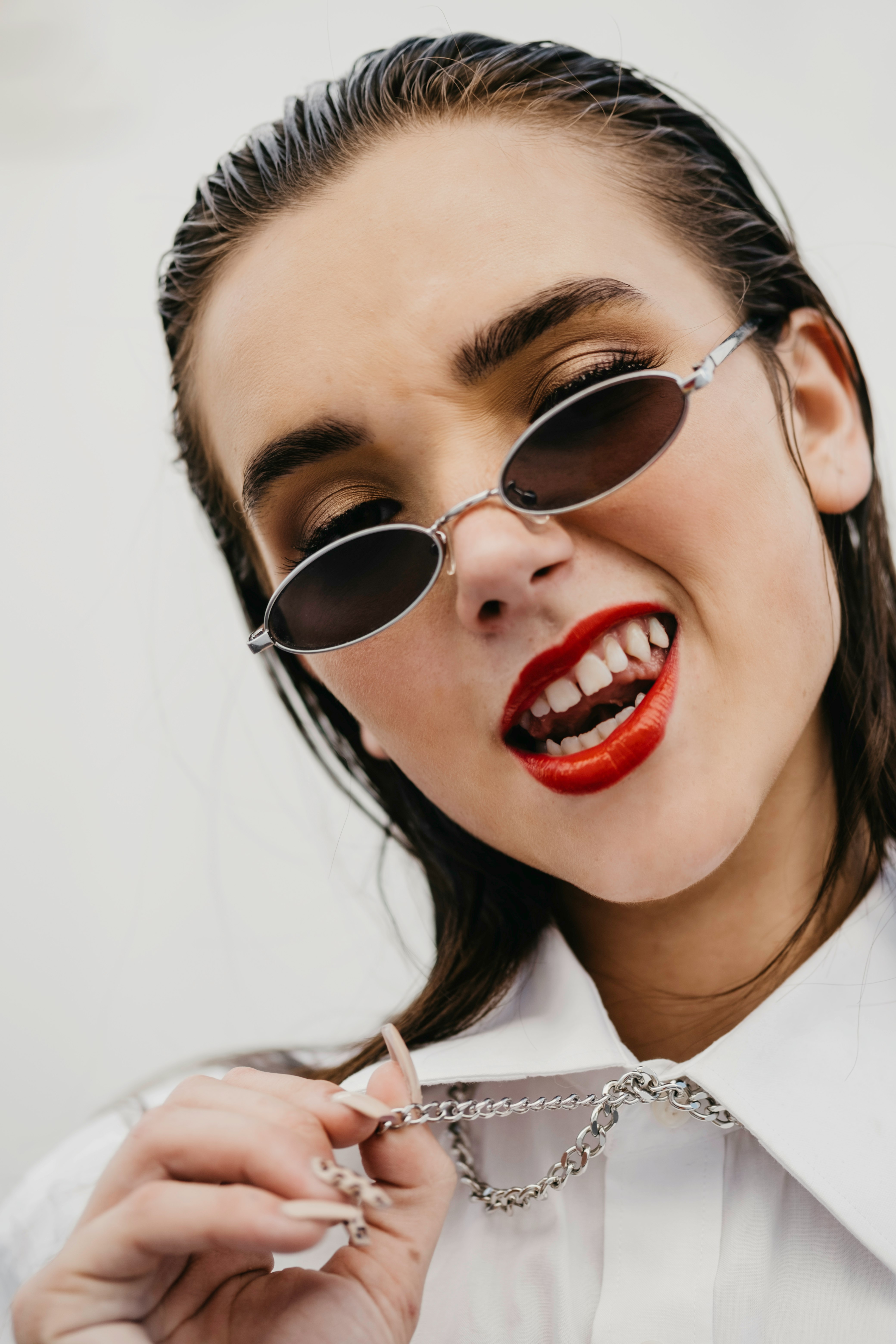 woman in white shirt wearing black sunglasses