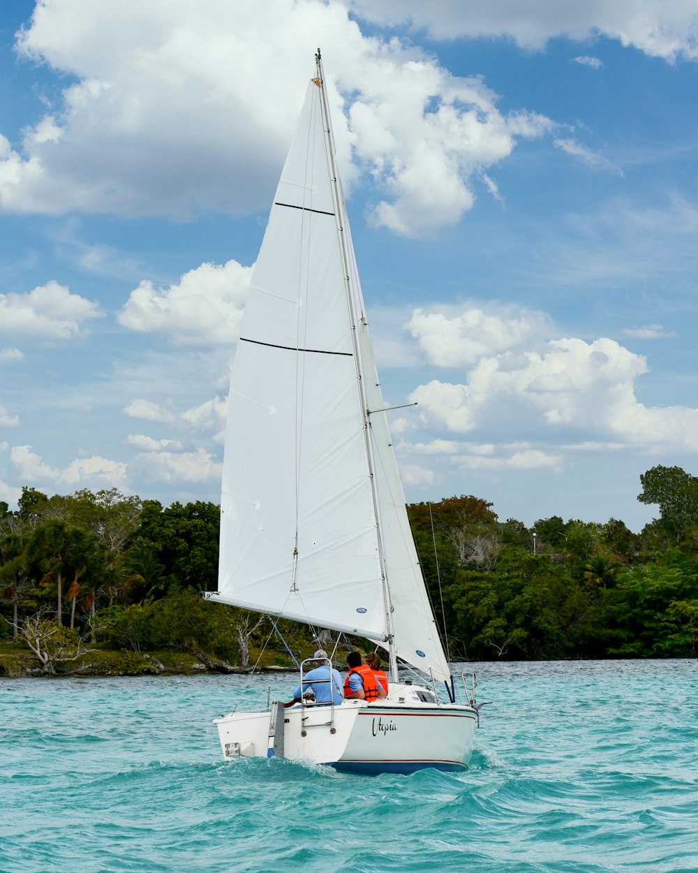 white sail boat on sea during daytime