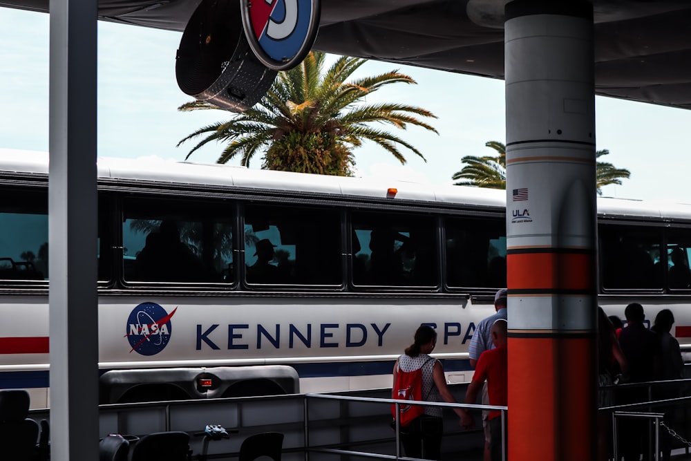 white and red bus on road during daytime