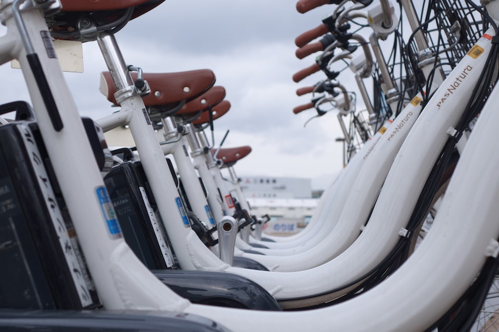 assorted bicycles on parking lot during daytime