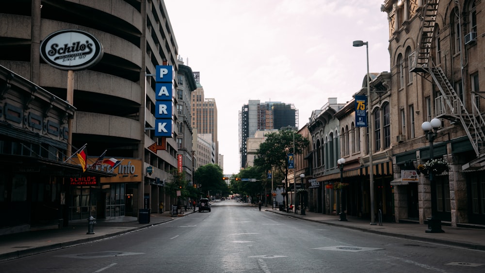 black asphalt road between high rise buildings during daytime