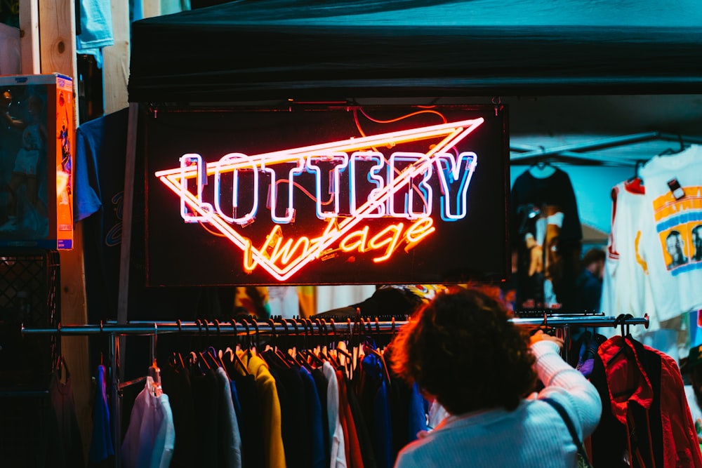 people in front of red and white UNKs neon light signage