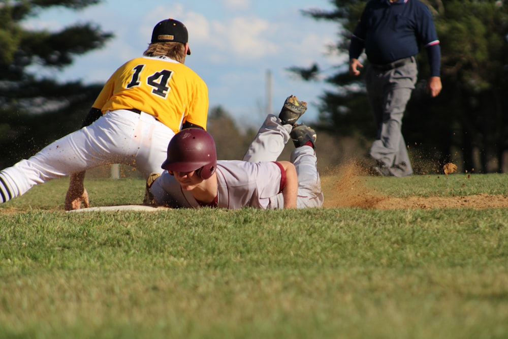 2 men in white and brown baseball jersey shirt and pants playing baseball during daytime