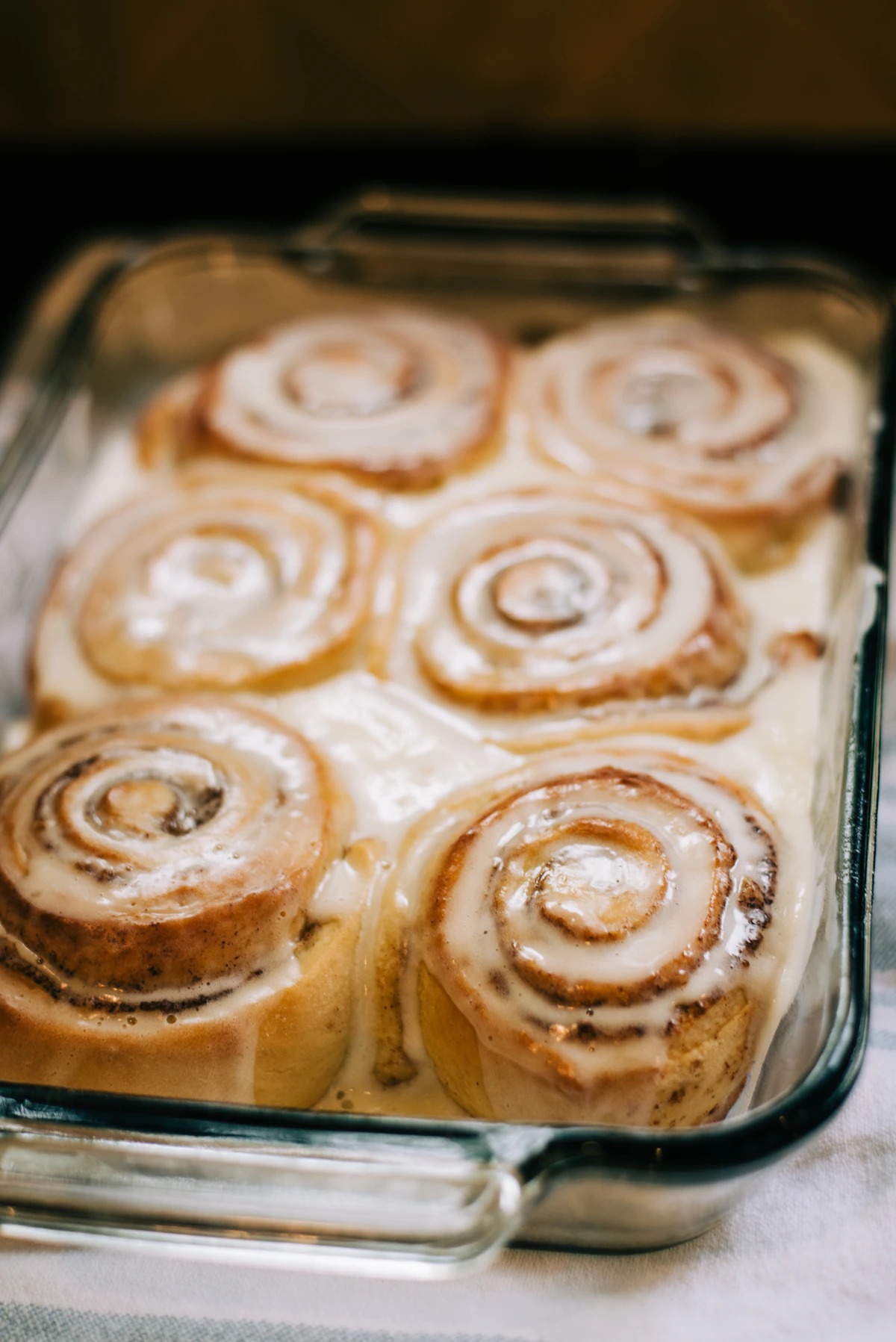 A cinnamon roll topped with cream cheese icing