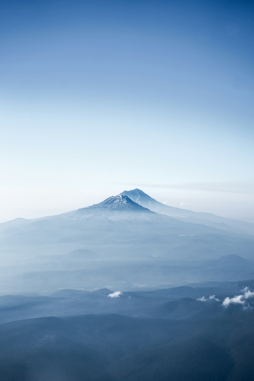 white clouds over snow covered mountain