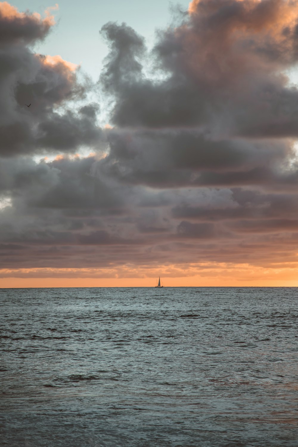 body of water under cloudy sky during daytime