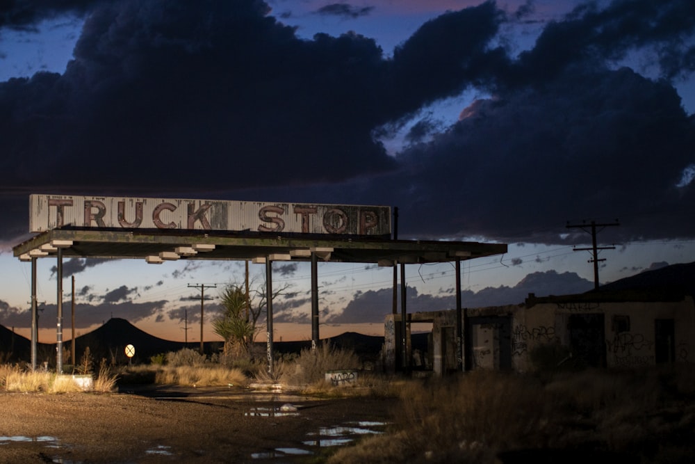 brown wooden signage near body of water during night time