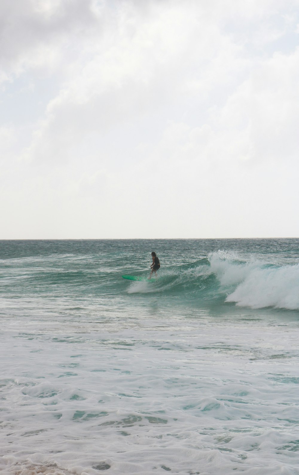 man surfing on sea waves during daytime