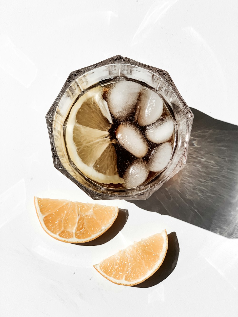 sliced orange fruit on clear glass bowl