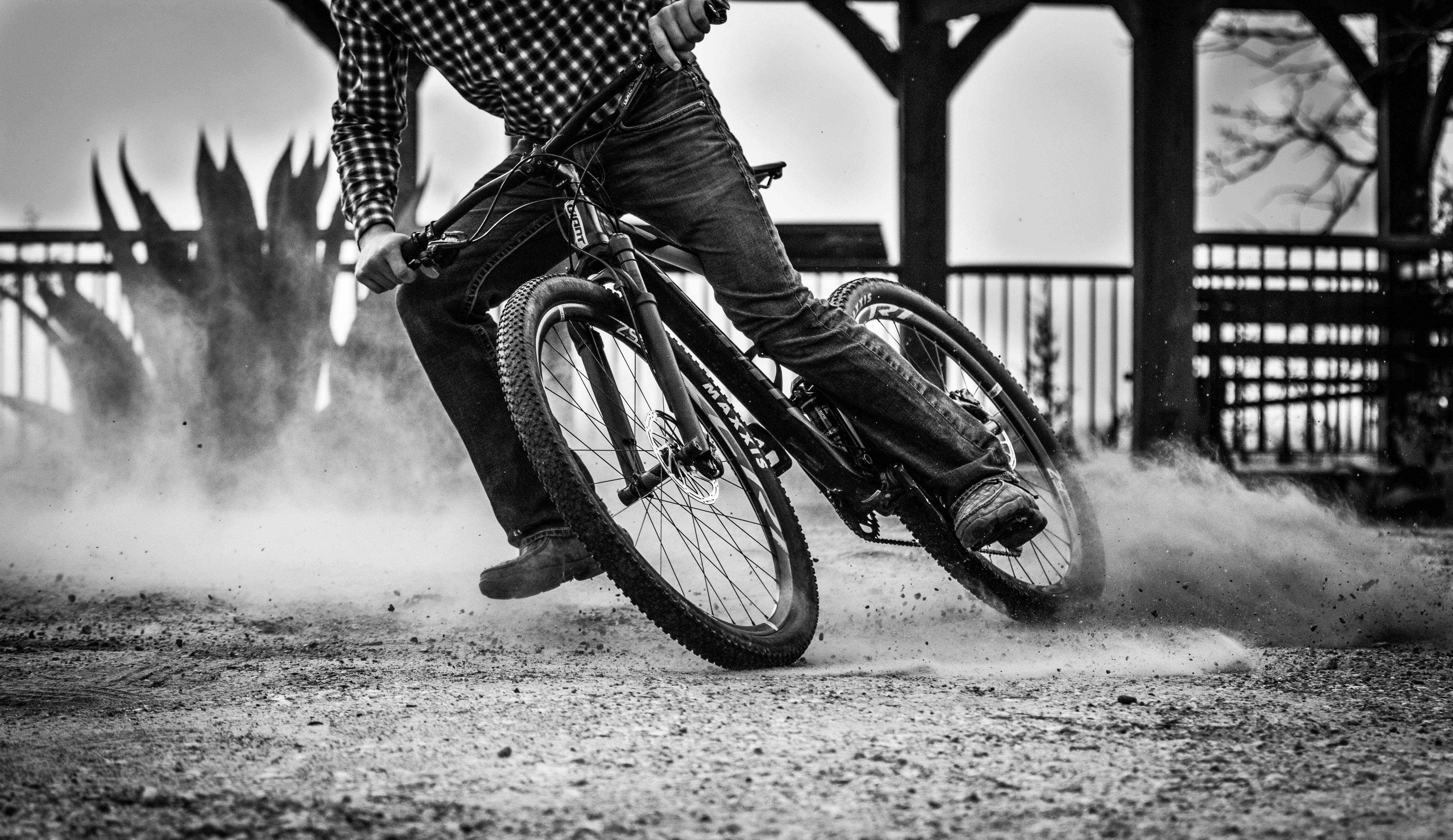 grayscale photo of person riding bicycle