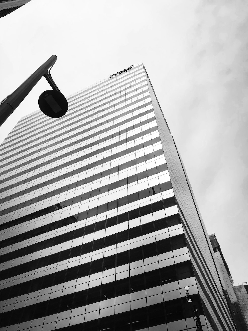 grayscale photo of street light near building