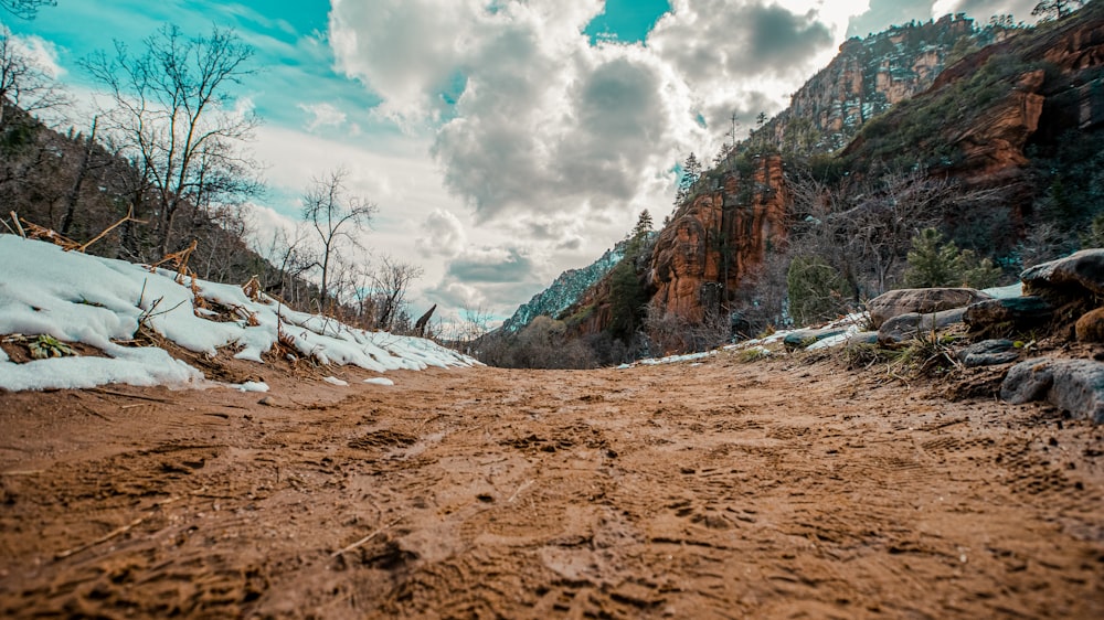 brown rocky mountain under white clouds and blue sky during daytime