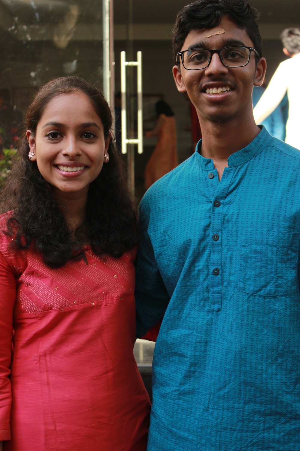 woman in red shirt beside woman in blue button up shirt