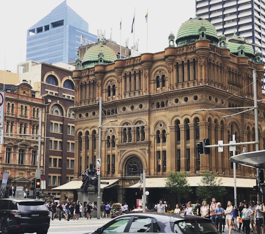 cars parked in front of brown building during daytime in Queen Victoria Building Australia