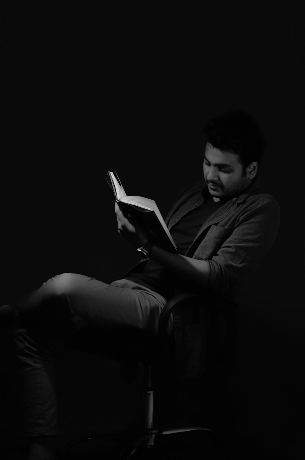 man in black long sleeve shirt reading book