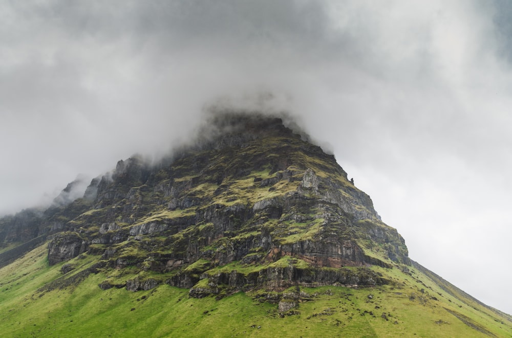 green and gray mountain under white clouds during daytime