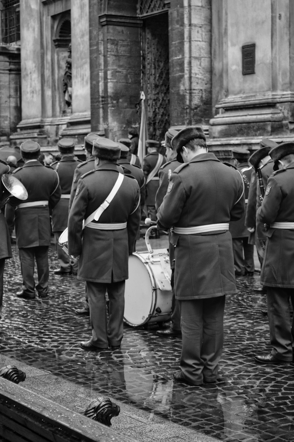 grayscale photo of people in front of building