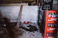 Stacks of heavy bottled water garrafas cluttering a small storage space.