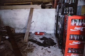 Stacks of heavy bottled water garrafas cluttering a small storage space.
