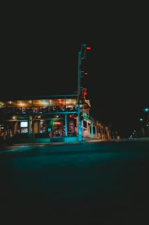The exterior of fight haus at dusk, glowing softly with inviting lights against the St. Thomas skyline.