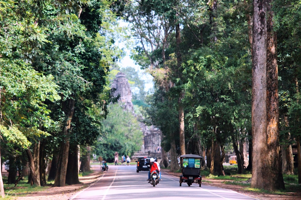 people riding motorcycle on road during daytime