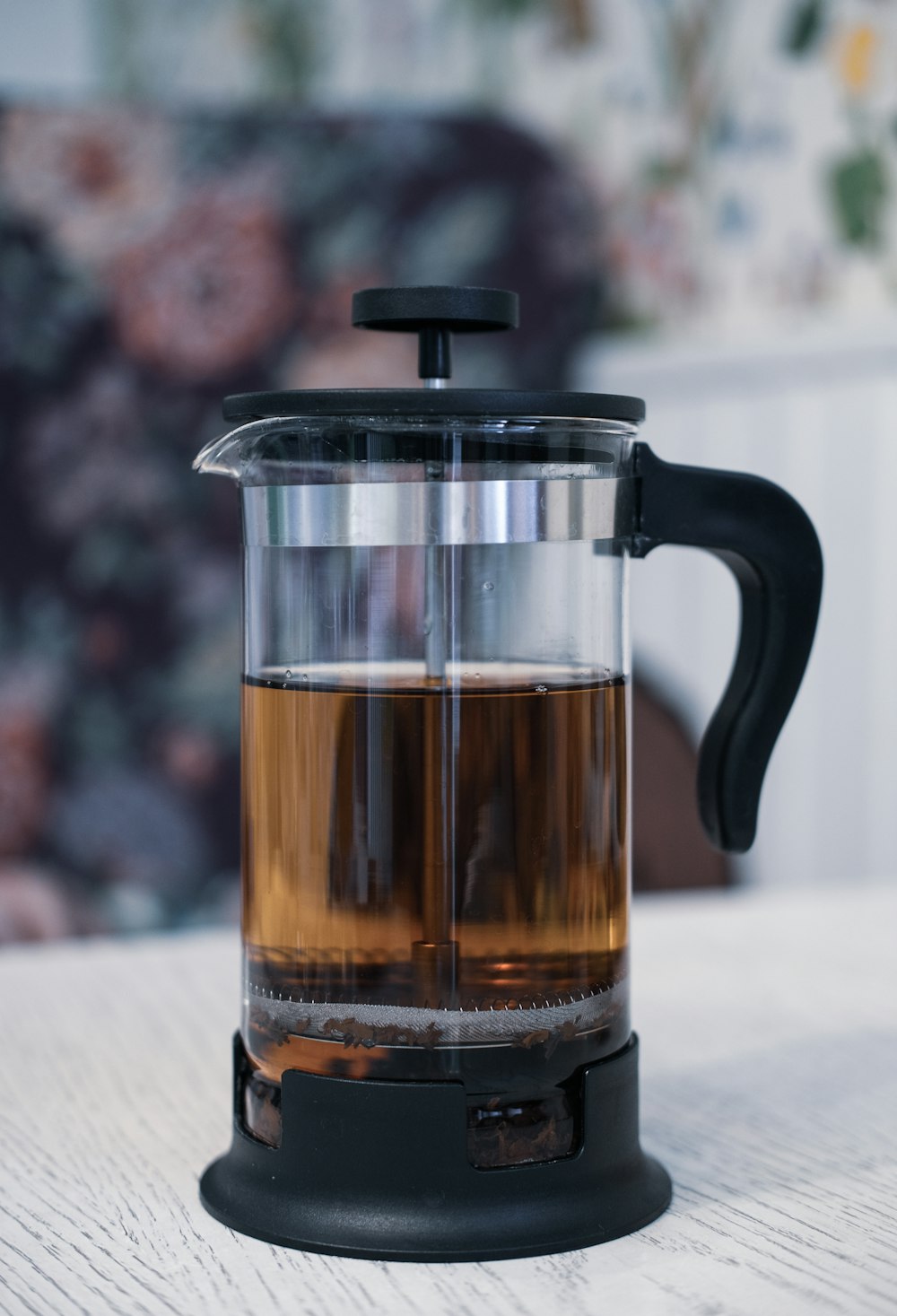 clear glass mug with brown liquid