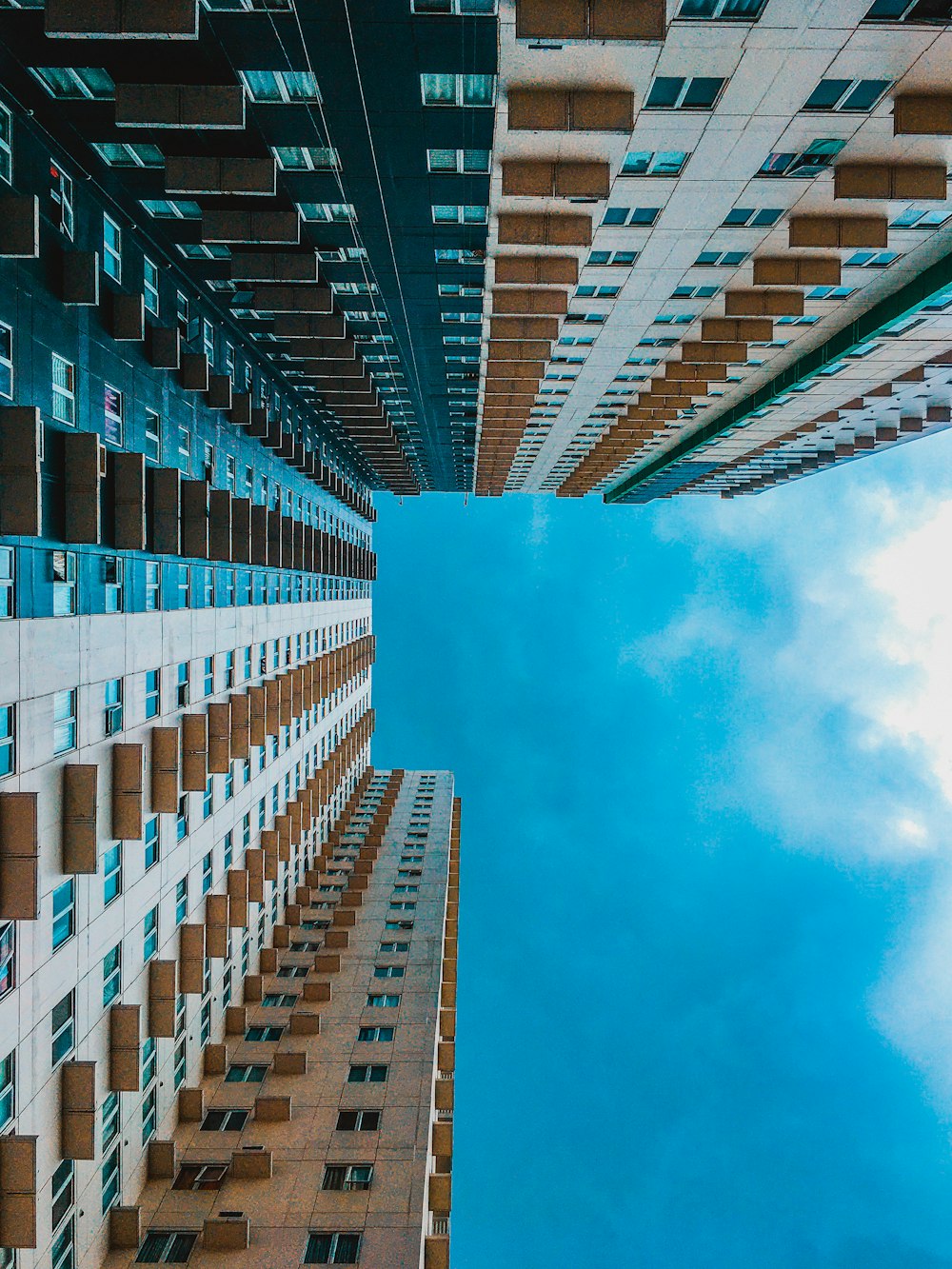 brown and white concrete building under blue sky during daytime