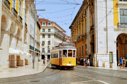yellow and white tram on road during daytime