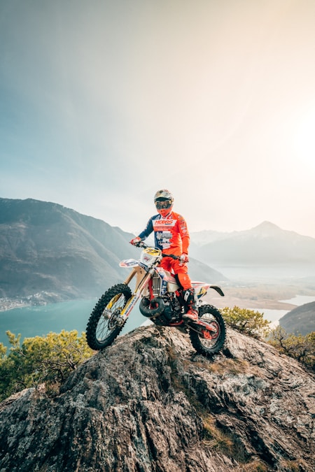 Enduro dirt bike and rider in mountainous open terrain