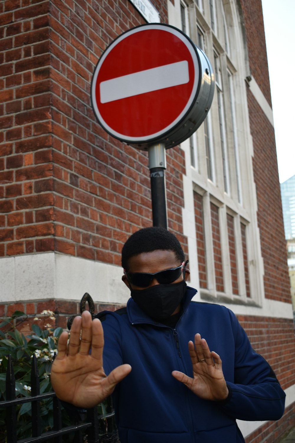 man in blue sweater wearing black sunglasses