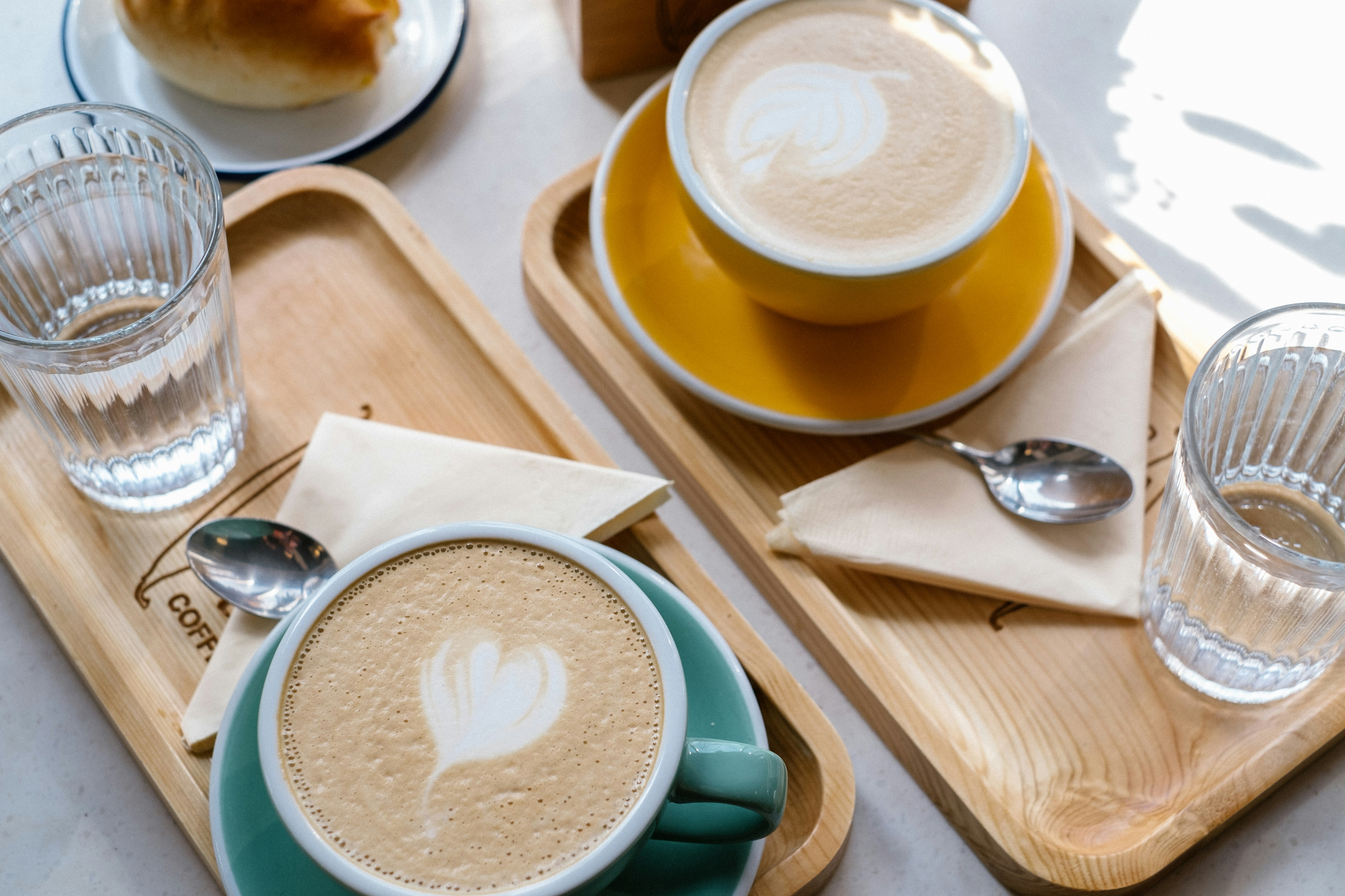 stainless steel spoon beside white ceramic bowl on brown wooden chopping board kazakhstan teams background
