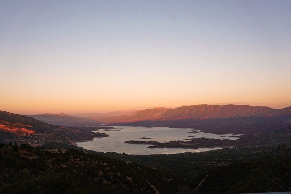 aerial view of lake and mountains during sunset