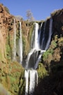 waterfalls in the middle of the forest during daytime