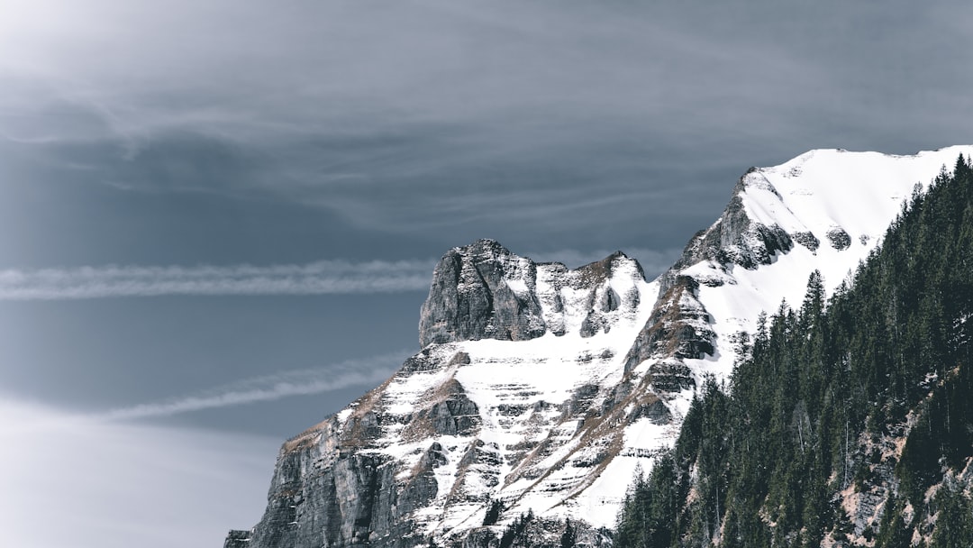 snow covered mountain under cloudy sky during daytime