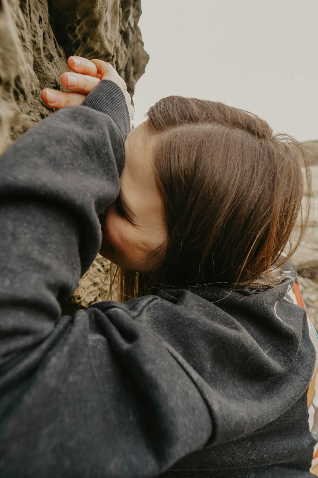 woman in gray hoodie looking at the sky